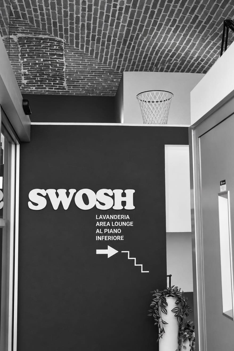 The sign just inside: laundry and lounge downstairs